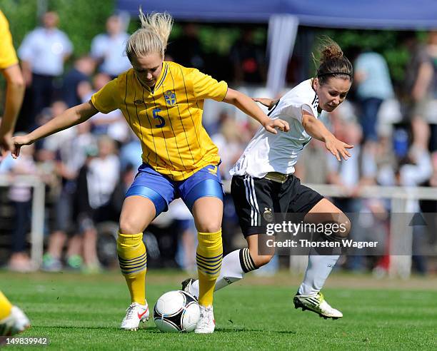 Jennifer Cramer of Germany battles for the ball with Magdalena Ericsson of Sweden during the women's U20 international friendly match between Germany...