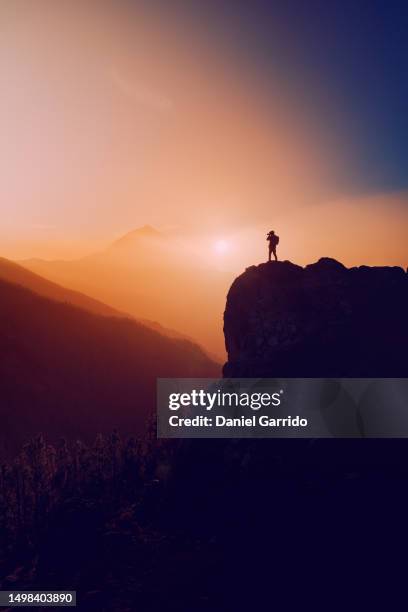 magical sunset in teide national park, photographer immortalizing the moment, landscape photographer in action - in a perfect world imagens e fotografias de stock