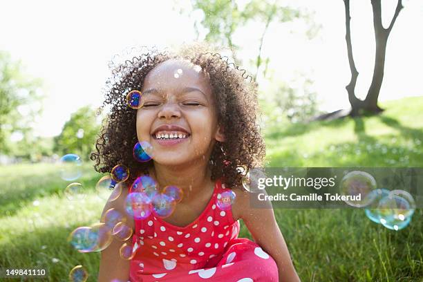 little girl playing with bubbles - day 6 photos et images de collection