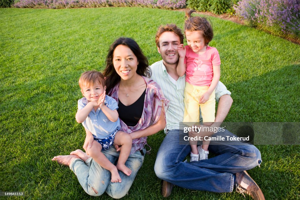 Portrait of a family sitting on grass