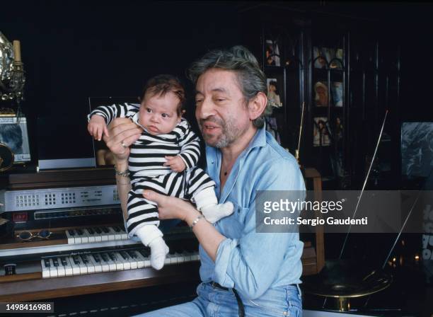 French singer and songwriter Serge Gainsbourg with his son Lulu in their Paris home on Rue de Verneuil.