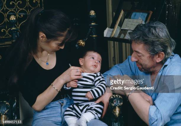 French singer and songwriter Serge Gainsbourg with his son Lulu and his wife Bambou in their Paris home on Rue de Verneuil.