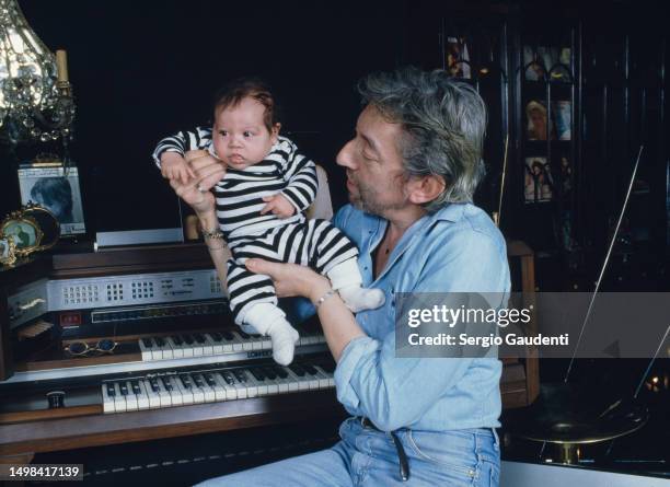 French singer and songwriter Serge Gainsbourg with his son Lulu in their Paris home on Rue de Verneuil.