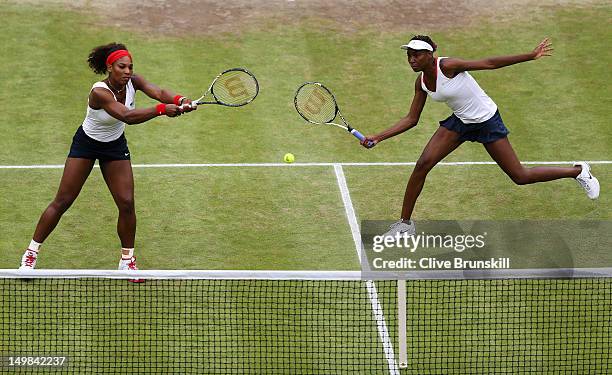 Serena Williams and Venus Williams of the United States return a shot against Andrea Hlavackova and Lucie Hradecka of Czech Republic during the...
