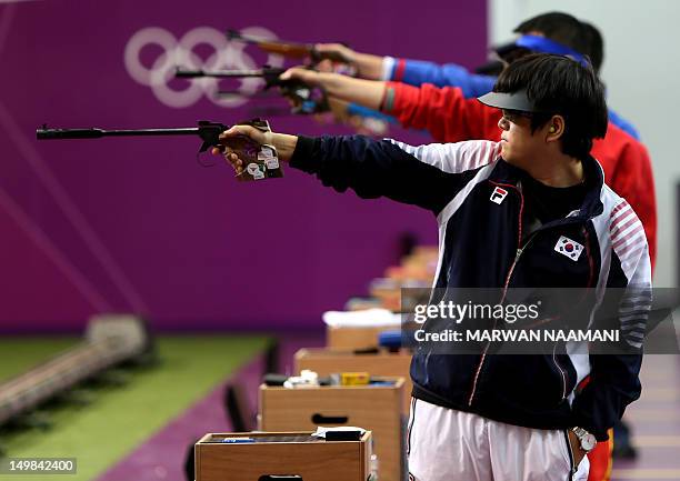 Silver medalist South Korea's Choi Young Rae competes with other shooters in the men's 50m pistol final at the London 2012 Olympic Games at the Royal...