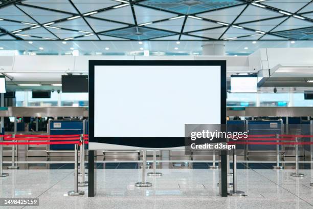 blank advertising billboard media display at the international airport. billboard with blank screen for design mockup - insegna commerciale foto e immagini stock