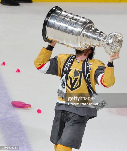 Mark Stone of the Vegas Golden Knights hoists the Stanley Cup after the team's 9-3 victory over the Florida Panthers in Game Five of the 2023 NHL...