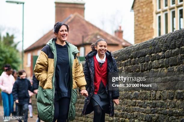 mother and daughter walking to school together, holding hands - multi ethnic group of kids stock pictures, royalty-free photos & images