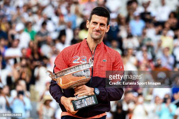 Novak Djokovic of Serbia poses for photos with his Champions trophy after winning Roland Garros 2023 Mens Single Final against Casper Ruud of Norway...