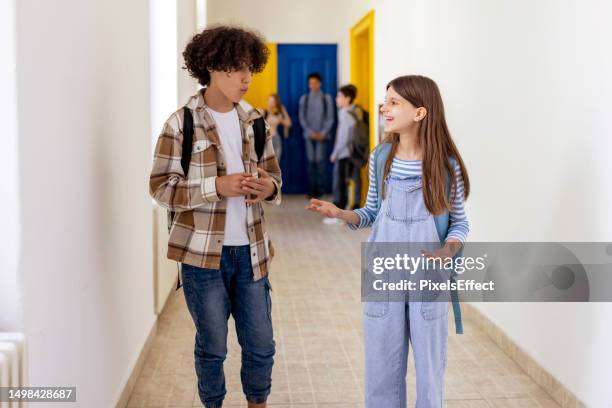 students talking in school hallway - girls conversation stock pictures, royalty-free photos & images
