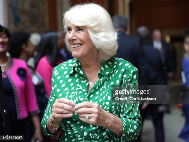 Queen Camilla smiles during a reception to mark the 75th anniversary of the arrival of HMT Empire Windrush at Buckingham Palace on June 14, 2023 in...