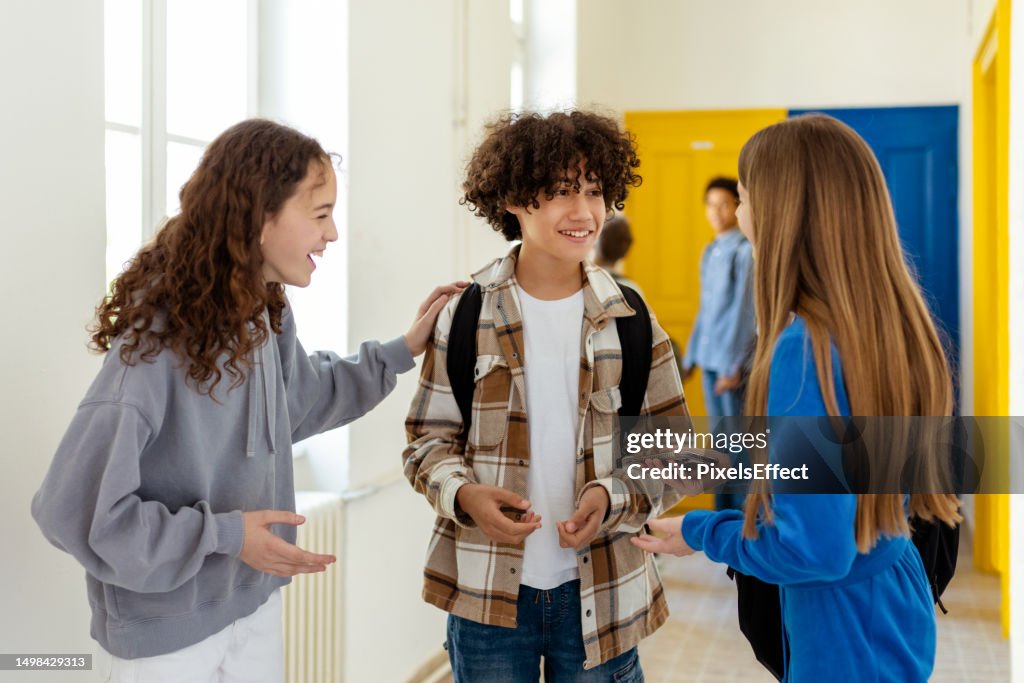 Estudiantes hablando juntos en un pasillo de la escuela