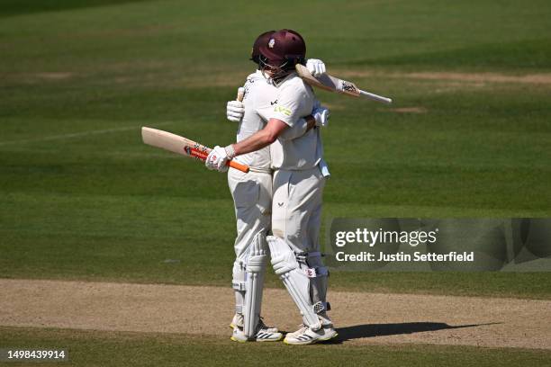 Dom Sibley of Surrey celebrates his 100 with Ben Foakes of Surrey during the LV= Insurance County Championship Division 1 match between Kent and...