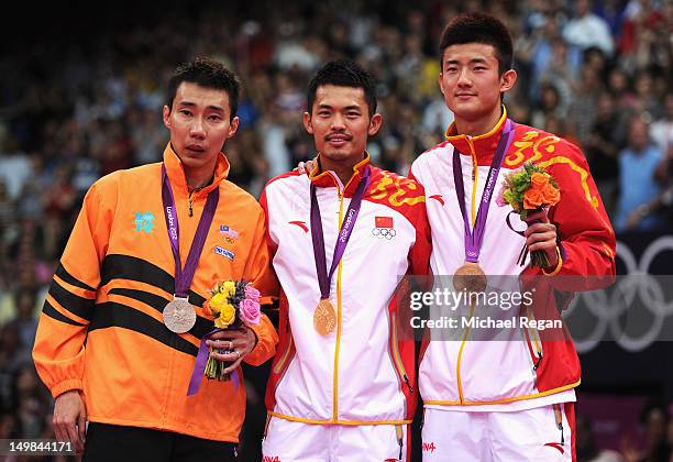 Lin Dan of China celebrates with his Gold medal on the podium, Chong Wei Lee of Malaysia the Silver and Long Chen of China the Bronze, following the...