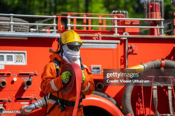 firefighter or emergency team rescue during fire fighting operation. - feuerwehrhelm stock-fotos und bilder