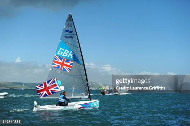 Ben Ainslie of Great Britain celebrates winning gold in the Finn Class Medal race at Weymouth Harbour on August 5, 2012 in Weymouth, England.