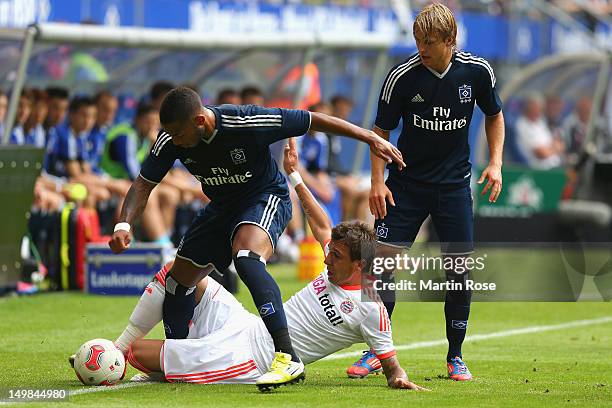 Dennis Aogo of Hamburg and Mario Mandzukic of Bayern Muenchen battle for the ball during the LIGA total! Cup 3rd place match between Hamburger SV and...