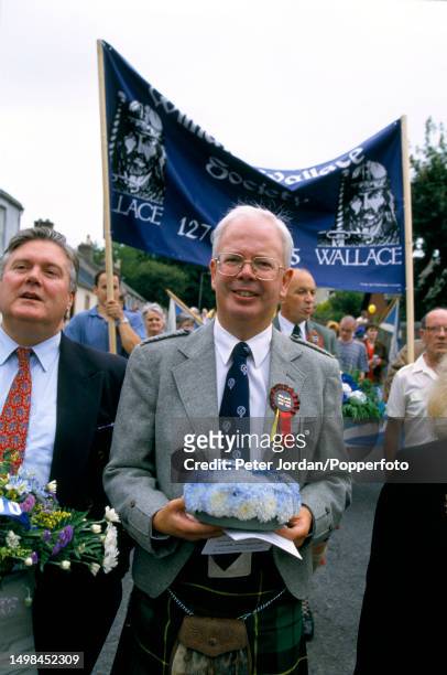 Liberal Party politician Jim Wallace, Leader of the Scottish Liberal Democrats, joins members of the Society of William Wallace as they take part in...