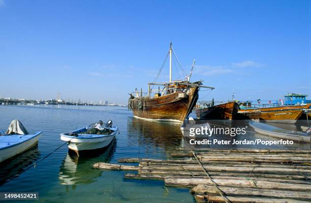 Recently built traditional wooden dhow sailing vessels moored at Dubai Creek in Dubai, United Arab Emirates in 1990.