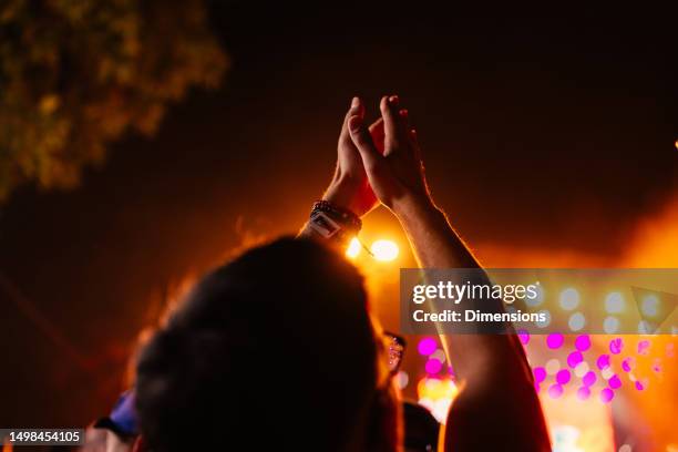 raised hands at music festival. - hands applauding stock pictures, royalty-free photos & images