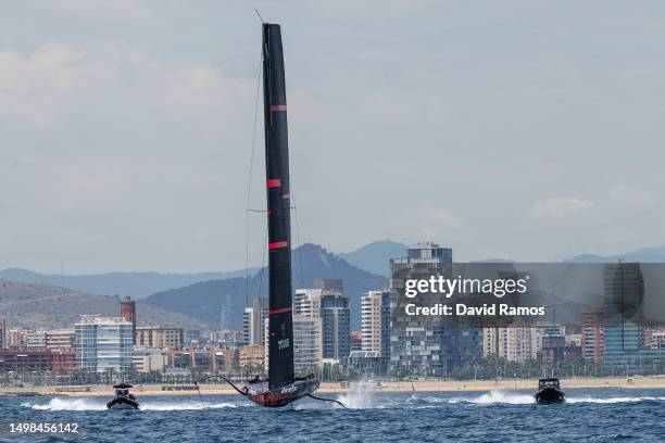 The Alinghi Red Bull Racing AC75 sails pass the Barcelona skyline during a training session on June 14, 2023 in Barcelona, Spain. The Alinghi Red...