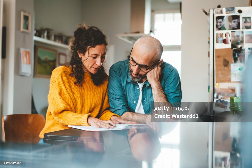 Man and woman preparing financial bills at home