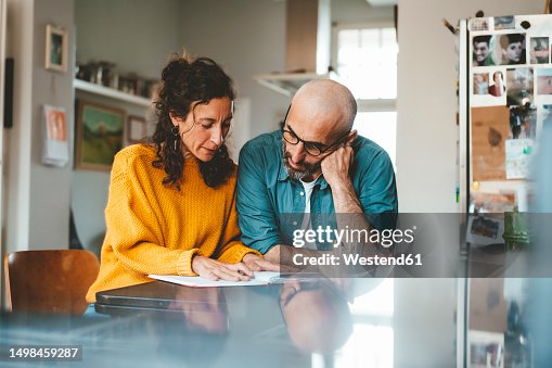 Man and woman preparing financial bills at home Man and woman preparing financial bills at home