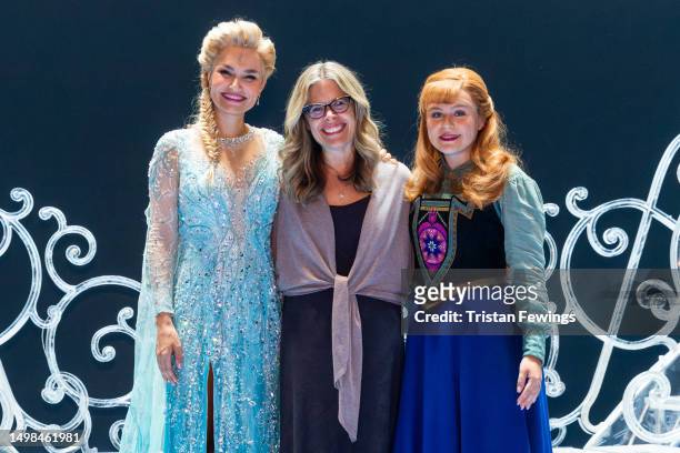 Samantha Barks as Elsa, Chief creative officer of Disney Jennifer Lee and Emily Lane as Anna pose onstage at "Frozen" at Theatre Royal Drury Lane on...