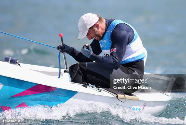 Ben Ainslie of Great Britain celebrates overall victory after competing in the Men's Finn Sailing Medal Race on Day 9 of the London 2012 Olympic...