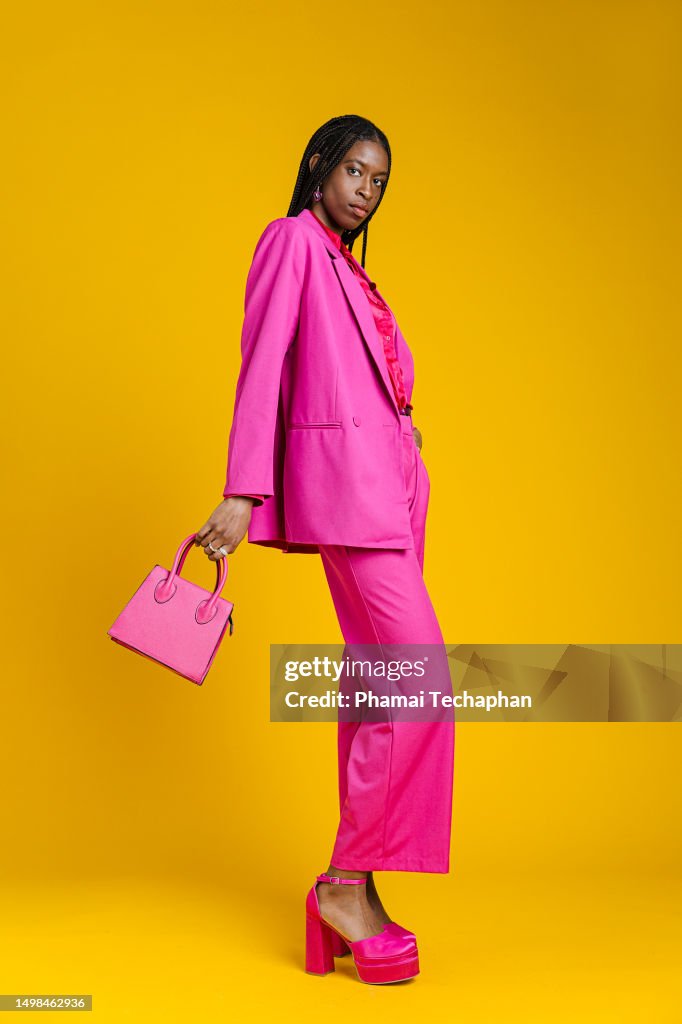 Fashionable woman in pink suit