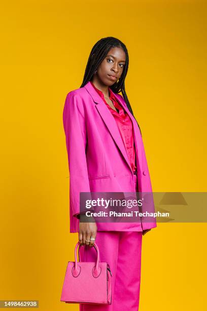 fashionable woman in pink suit - pink purse stock pictures, royalty-free photos & images