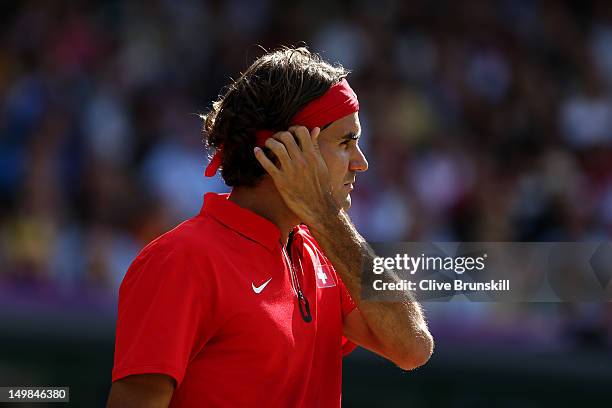 Roger Federer of Switzerland looks on against Andy Murray of Great Britain during the Men's Singles Tennis Gold Medal Match on Day 9 of the London...