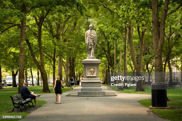 people walk on back bay park path of commonwealth avenue mall in boston massachusetts usa - revolution esplanade monument stock pictures, royalty-free photos & images