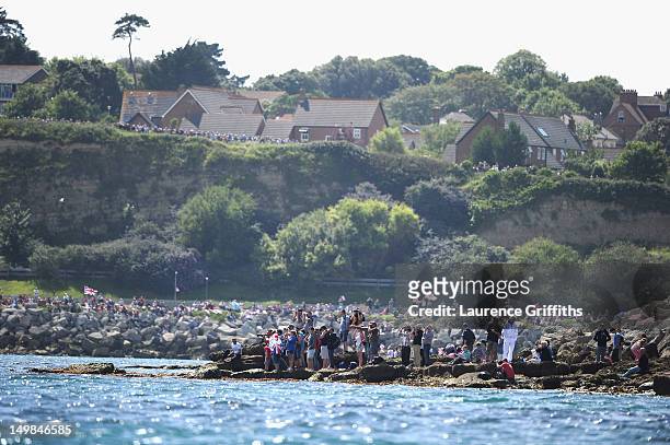 Fans gather on the Nothe to watch Ben Ainslie of Great Britain win gold at Weymouth Harbour on August 5, 2012 in Weymouth, England.