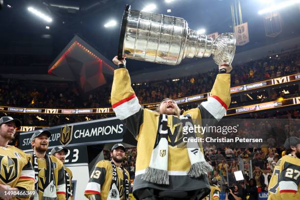 William Karlsson of the Vegas Golden Knights hoists the Stanley Cup after a win against the Florida Panthers in Game Five of the 2023 NHL Stanley Cup...