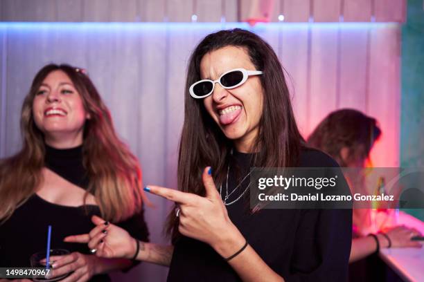 woman in sunglasses joking inside a club - cocaine woman stock pictures, royalty-free photos & images