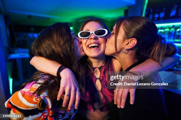 three friends kissing while partying in a disco - dance floor stock pictures, royalty-free photos & images