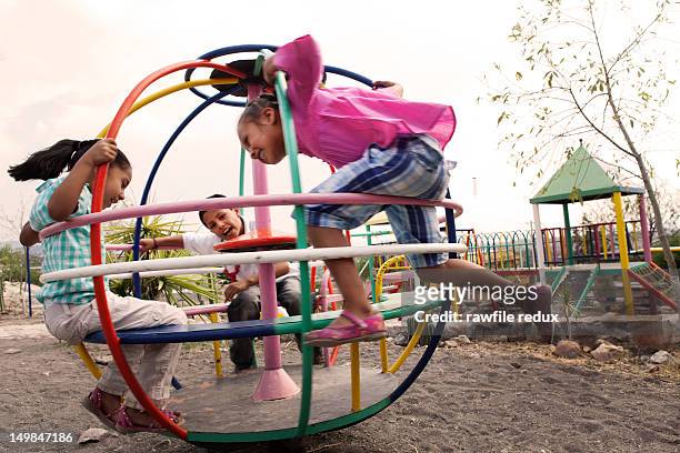 kids playing a spinning game. - playground stock pictures, royalty-free photos & images