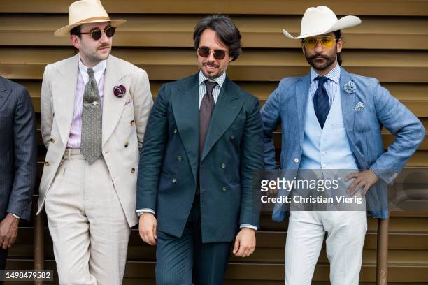 Guests wearing suits, cowboy hat during Pitti Immagine Uomo 104 on June 14, 2023 in Florence, Italy.