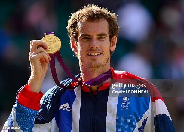 Great Britain's Andy Murray poses with his gold medal at the end of the men's singles tennis tournament of the London 2012 Olympic Games, at the All...