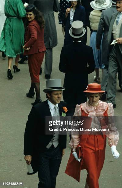 Elevated view of bodyguard Graham Smith and Lady Diana Spencer as they walk together during the Royal Ascot at the Ascot Racecourse, Ascot, England,...