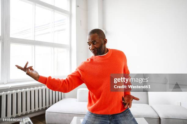 mature man practicing karate moves at home - martial arts man stock pictures, royalty-free photos & images