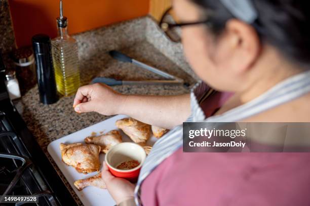 woman preparing chicken for barbecue - thigh stock pictures, royalty-free photos & images