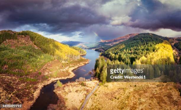 uk, scotland,storm clouds over loch doilean with rainbow in the background - loch moidart stock pictures, royalty-free photos & images