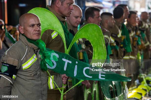 Firefighters stage an honour guard during the sixth anniversary Silent Walk on June 14, 2023 in London, England. A fire broke out in Grenfell Tower,...