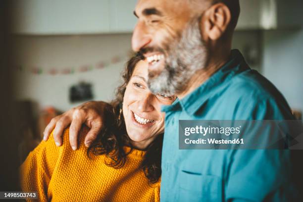 happy woman leaning on man shoulder at home - 40 44 years stock pictures, royalty-free photos & images