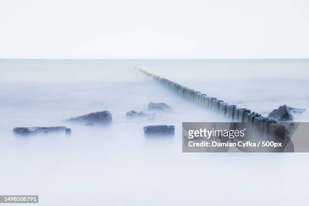 scenic view of sea against sky during foggy weather,gdynia,poland - groyne photos et images de collection