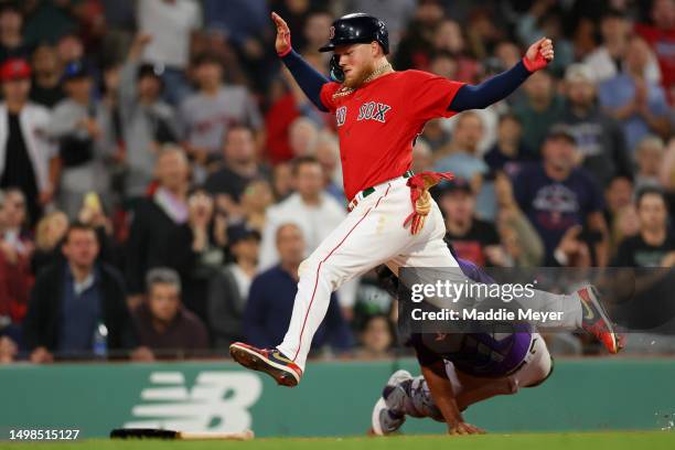 Alex Verdugo of the Boston Red Sox is tagged out at home plate by Elias Diaz of the Colorado Rockies during the fifth inning at Fenway Park on June...