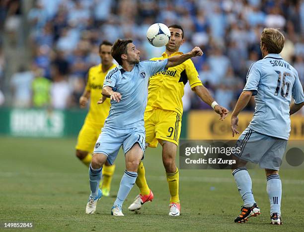 Bobby Convey of the Sporting Kansas City vie for the ball against Justin Meram of the Columbus Crew at Livestrong Sporting Park on July 28, 2012 in...