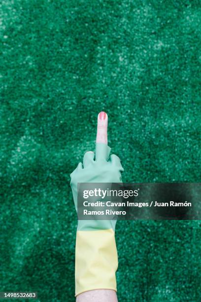 old lady showing her middle finger in a broken plastic glove - old lady middle finger - fotografias e filmes do acervo